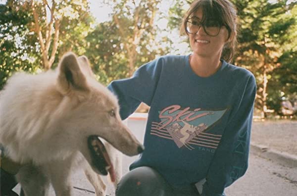 Fleur Fortune petting a big white dog and wearing a blue "ski" shirt.
