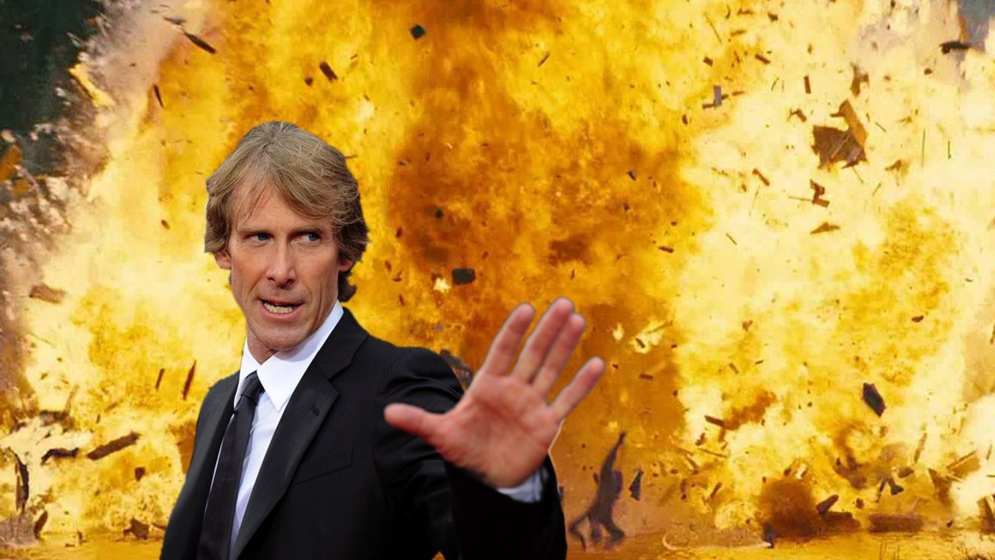 Michael Bay with a large explosion in the back ground.